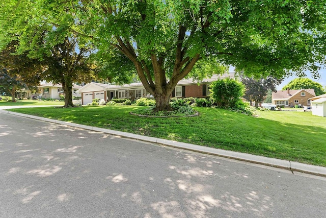 435 S Main St, Markesan, WI 53946 - ranch-style house featuring a garage, a front lawn, and a residential view