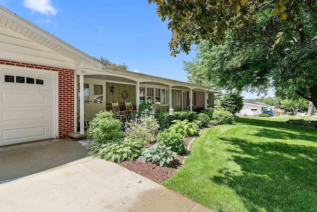 435 S Main St, Markesan, WI 53946 - view of exterior entry featuring brick siding, a lawn, and a garage