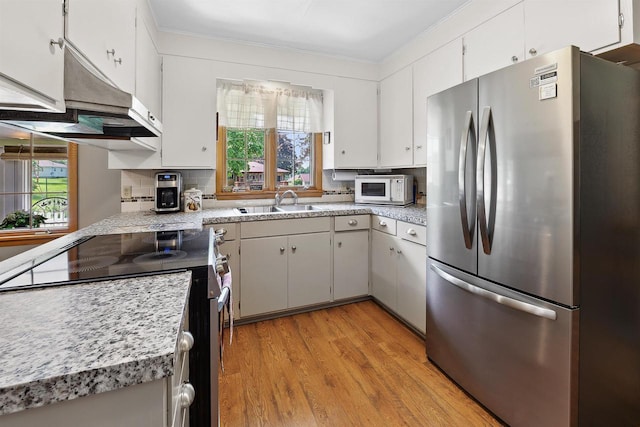 435 S Main St, Markesan, WI 53946 - kitchen with appliances with stainless steel finishes, plenty of natural light, light wood finished floors, light countertops, and crown molding