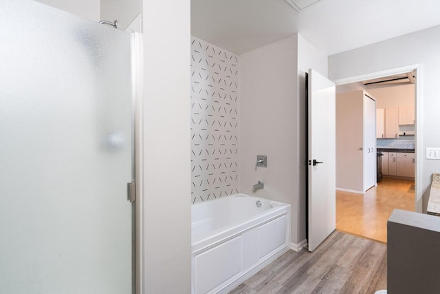 1924 N Hubbard St Unit 109, Milwaukee, WI 53212 - bathroom with a shower, wood finished floors, a tub to relax in, and decorative backsplash