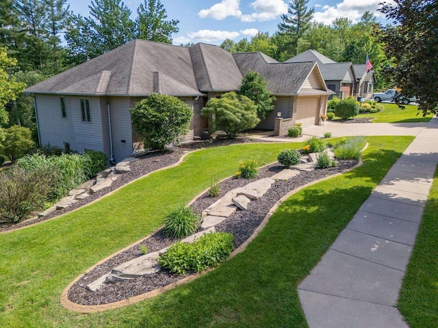 303 Rimrock Rd, Wausau, WI 54401 - view of front of home with an attached garage, a front lawn, concrete driveway, and brick siding