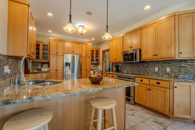 303 Rimrock Rd, Wausau, WI 54401 - kitchen with stainless steel appliances, a peninsula, a kitchen breakfast bar, glass insert cabinets, and decorative backsplash