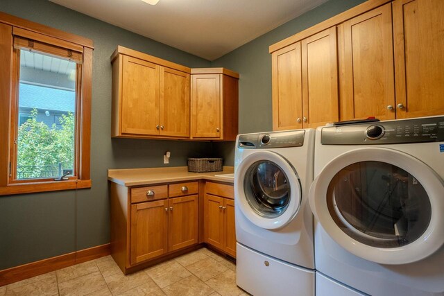 303 Rimrock Rd, Wausau, WI 54401 - washroom featuring cabinet space, washer and dryer, and light tile patterned floors