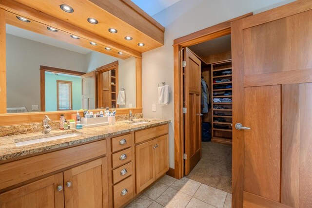 303 Rimrock Rd, Wausau, WI 54401 - bathroom featuring double vanity, tile patterned floors, recessed lighting, and a walk in closet