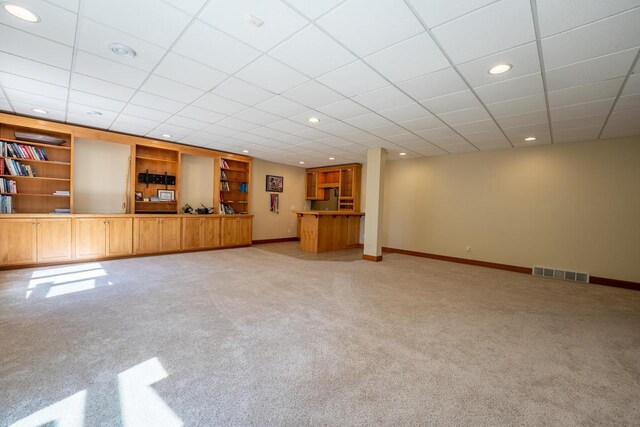 303 Rimrock Rd, Wausau, WI 54401 - unfurnished living room with light colored carpet, recessed lighting, built in shelves, and a drop ceiling