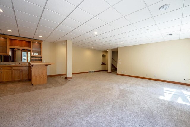 303 Rimrock Rd, Wausau, WI 54401 - unfurnished living room with light carpet, stairway, recessed lighting, and a drop ceiling