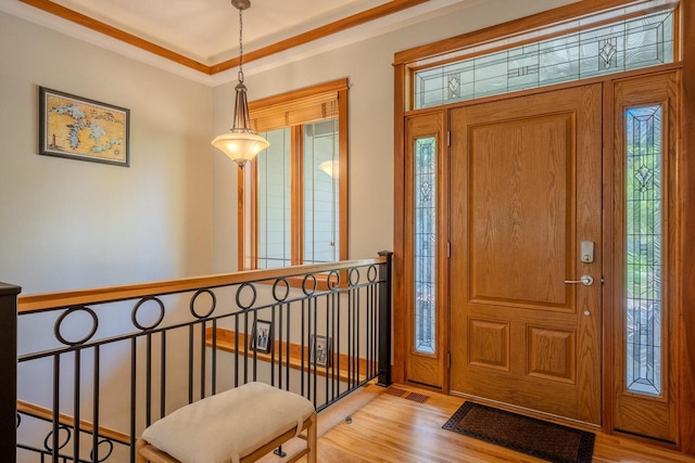 303 Rimrock Rd, Wausau, WI 54401 - entryway featuring light wood finished floors and ornamental molding
