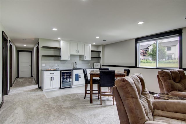 2247 105th St, Eau Claire, WI 54703 - kitchen with beverage cooler, open shelves, open floor plan, white cabinets, and dark countertops