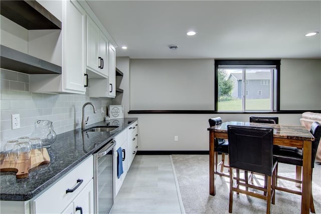 2247 105th St, Eau Claire, WI 54703 - kitchen with beverage cooler, dark stone counters, white cabinetry, tasteful backsplash, and recessed lighting