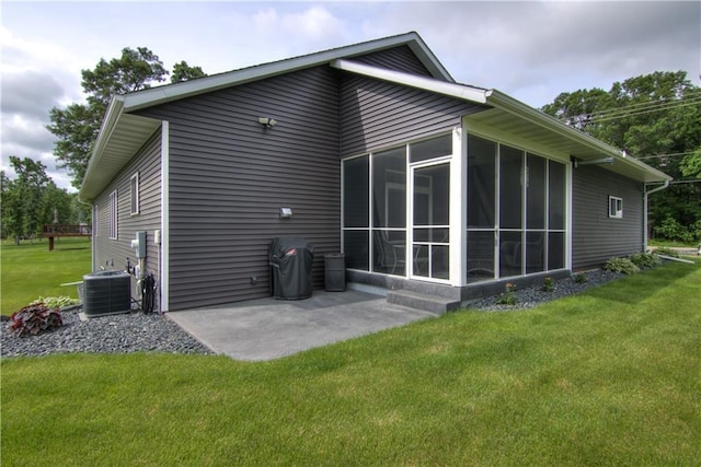 2247 105th St, Eau Claire, WI 54703 - rear view of house featuring a sunroom, a lawn, and a patio