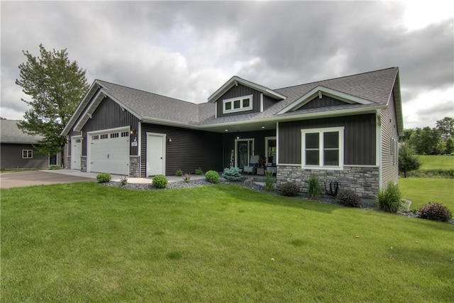 2247 105th St, Eau Claire, WI 54703 - craftsman-style home featuring stone siding, a garage, a front yard, a shingled roof, and driveway