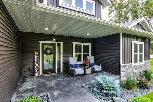 2247 105th St, Eau Claire, WI 54703 - property entrance with board and batten siding, stone siding, and a patio area