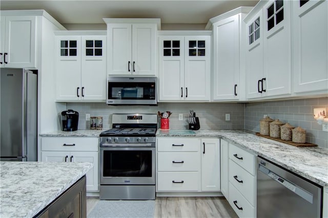2247 105th St, Eau Claire, WI 54703 - kitchen featuring stainless steel appliances, white cabinets, and glass insert cabinets