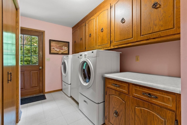 2929 Brunner Rd, Manitowoc, WI 54220 - washroom featuring cabinet space, washer and clothes dryer, and light tile patterned floors