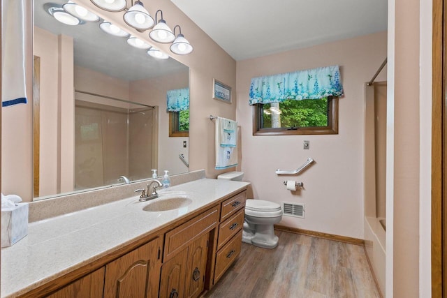 2929 Brunner Rd, Manitowoc, WI 54220 - full bath featuring vanity, wood finished floors, and shower / bathtub combination