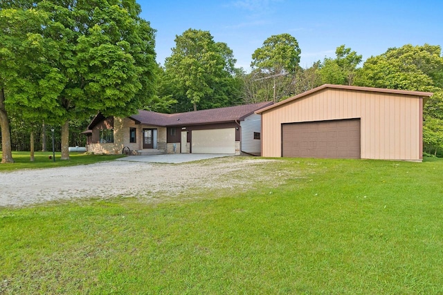 2929 Brunner Rd, Manitowoc, WI 54220 - view of front of property with a front yard, a detached garage, and stone siding