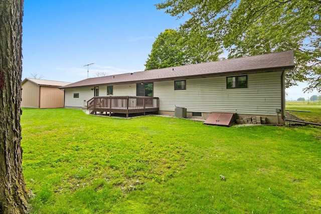 2929 Brunner Rd, Manitowoc, WI 54220 - back of house featuring a wooden deck and a lawn