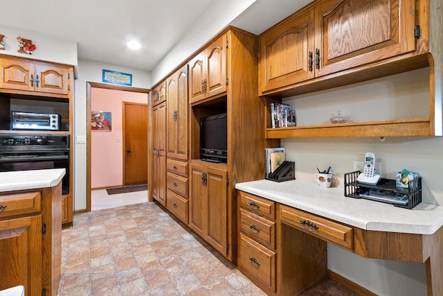 2929 Brunner Rd, Manitowoc, WI 54220 - kitchen featuring black oven, brown cabinets, and open shelves