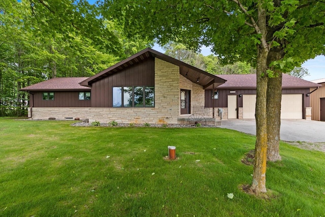 2929 Brunner Rd, Manitowoc, WI 54220 - view of front of home featuring stone siding, driveway, roof with shingles, a garage, and board and batten siding