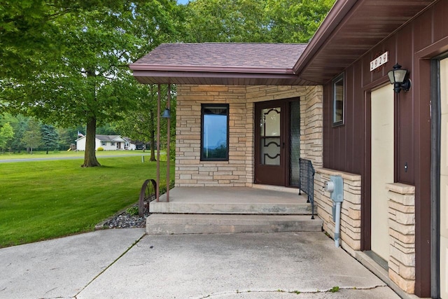 2929 Brunner Rd, Manitowoc, WI 54220 - property entrance with a yard, a shingled roof, and stone siding