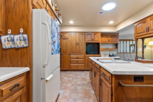 2929 Brunner Rd, Manitowoc, WI 54220 - kitchen with freestanding refrigerator, brown cabinetry, light countertops, and recessed lighting