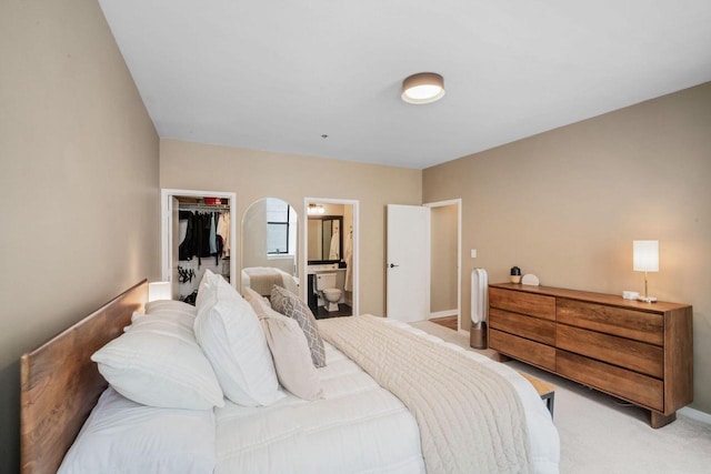 234 N Broadway Unit 402, Milwaukee, WI 53202 - bedroom with light colored carpet, a spacious closet, a closet, and ensuite bathroom