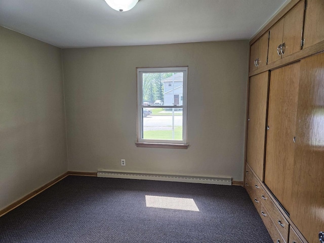 450 N Cecil St, Bonduel, WI 54107 - unfurnished bedroom with a baseboard heating unit, carpet flooring, and a closet