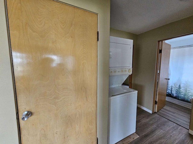 450 N Cecil St, Bonduel, WI 54107 - washroom featuring stacked washing machine and dryer and wood finished floors