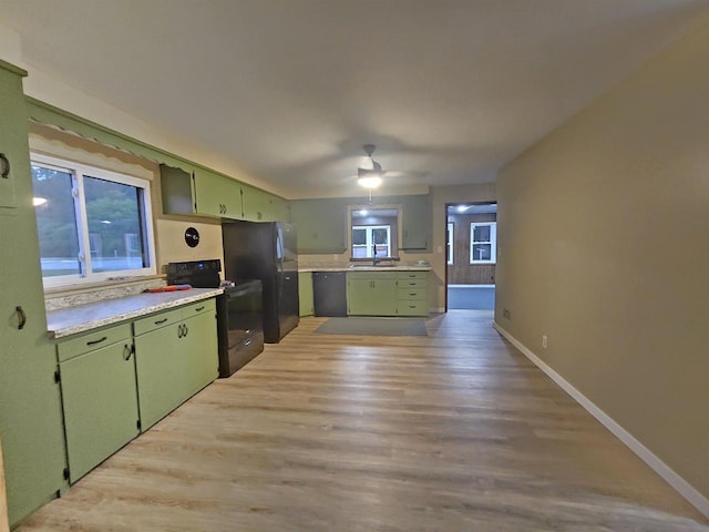 450 N Cecil St, Bonduel, WI 54107 - kitchen with green cabinetry, black appliances, light countertops, light wood-type flooring, and ceiling fan