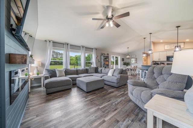 N3366 Flynn Dr, Montello, WI 53949 - living room with a fireplace, vaulted ceiling, a ceiling fan, dark wood-style floors, and recessed lighting