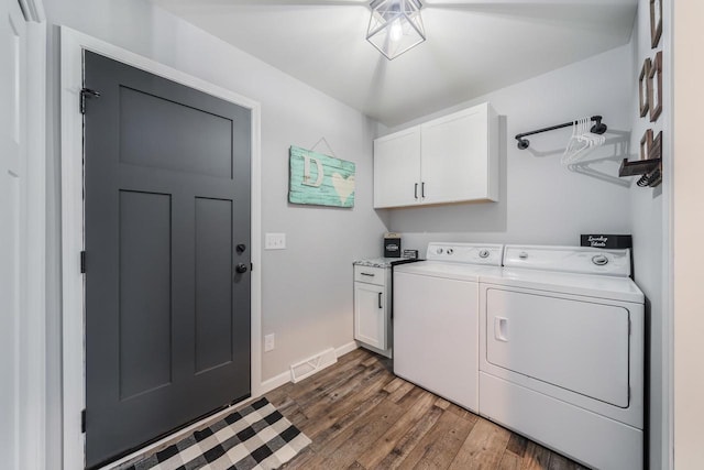 N3366 Flynn Dr, Montello, WI 53949 - laundry area featuring cabinet space, separate washer and dryer, and wood finished floors