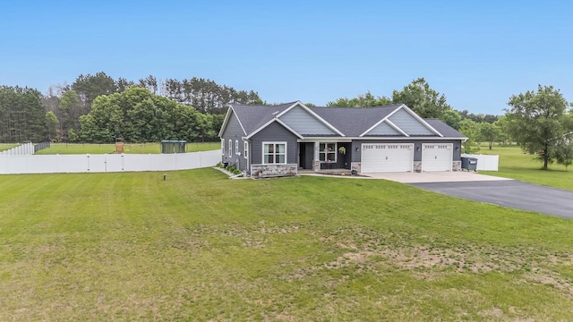 N3366 Flynn Dr, Montello, WI 53949 - craftsman-style house with an attached garage, stone siding, driveway, and a porch
