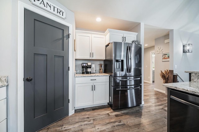 N3366 Flynn Dr, Montello, WI 53949 - kitchen featuring stainless steel refrigerator with ice dispenser, dishwashing machine, dark wood-style flooring, white cabinetry, and light stone countertops