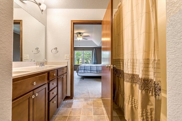 739 Pinehurst Dr, Mukwonago, WI 53149 - ensuite bathroom with a textured wall, double vanity, ceiling fan, a shower with curtain, and a textured ceiling