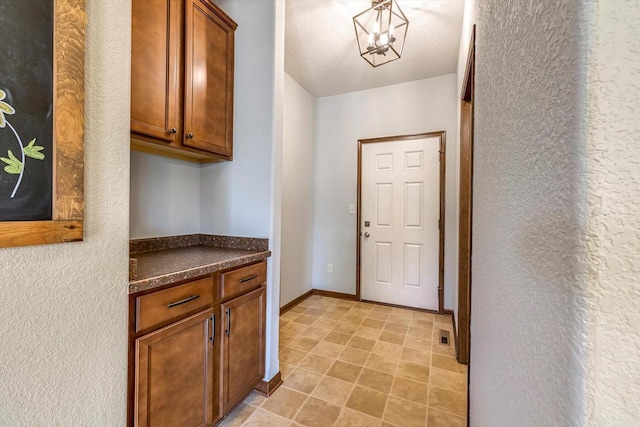 739 Pinehurst Dr, Mukwonago, WI 53149 - laundry room with baseboards and a textured wall