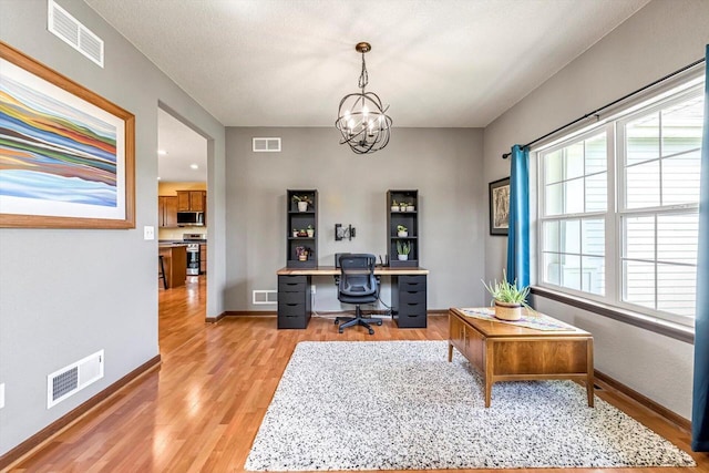 739 Pinehurst Dr, Mukwonago, WI 53149 - office area featuring light wood-style flooring, a chandelier, and healthy amount of natural light