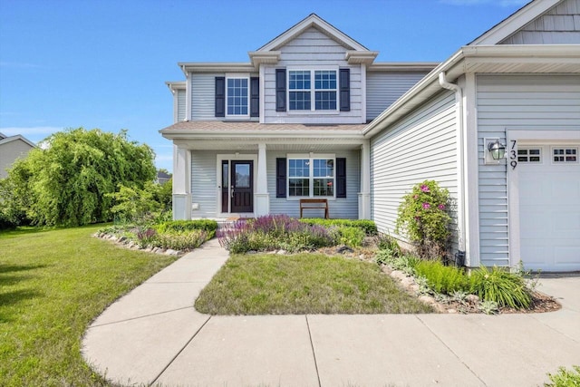 739 Pinehurst Dr, Mukwonago, WI 53149 - view of front of house featuring a porch, a front yard, and a garage