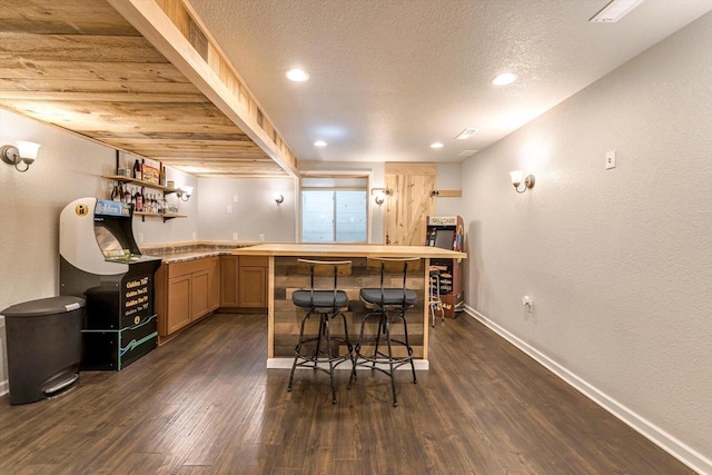 739 Pinehurst Dr, Mukwonago, WI 53149 - indoor wet bar with dark wood-style floors, a textured ceiling, and a textured wall