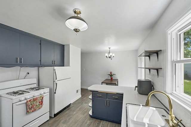 1007 14th Ave, Green Bay, WI 54304 - kitchen featuring white appliances, open shelves, a peninsula, blue cabinets, and light countertops