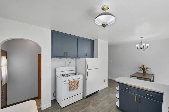 1007 14th Ave, Green Bay, WI 54304 - kitchen with white appliances, blue cabinetry, arched walkways, and dark wood finished floors