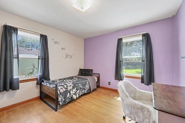 1007 14th Ave, Green Bay, WI 54304 - bedroom with multiple windows and light wood-type flooring
