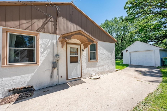 1007 14th Ave, Green Bay, WI 54304 - property entrance with stucco siding, concrete driveway, and a garage
