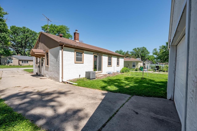 1007 14th Ave, Green Bay, WI 54304 - rear view of house featuring a chimney, a yard, and a patio
