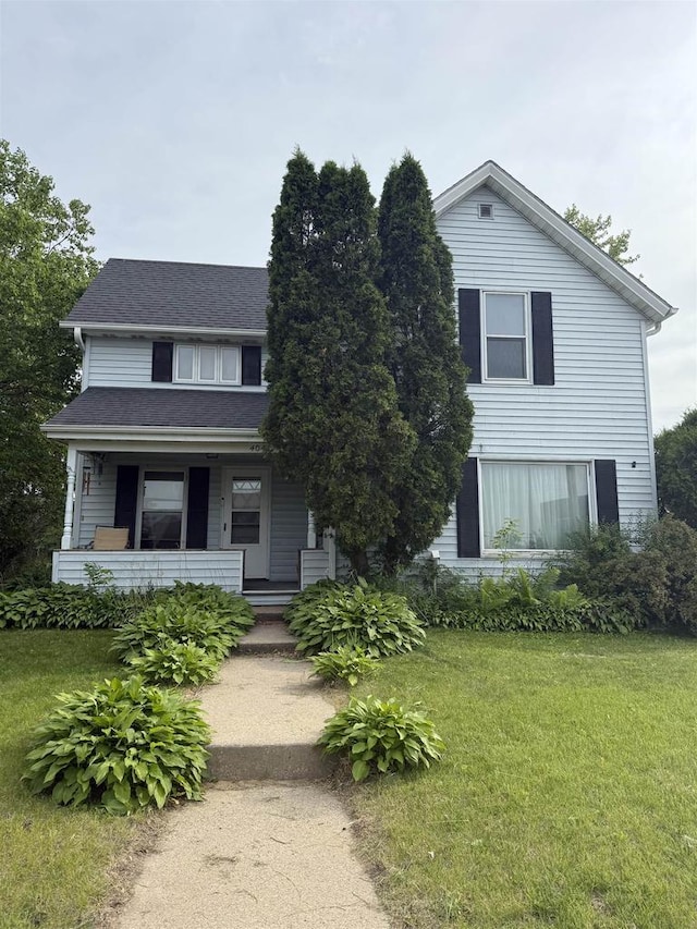 404 Prairie St, Mauston, WI 53948 - view of front of home featuring a front lawn and covered porch