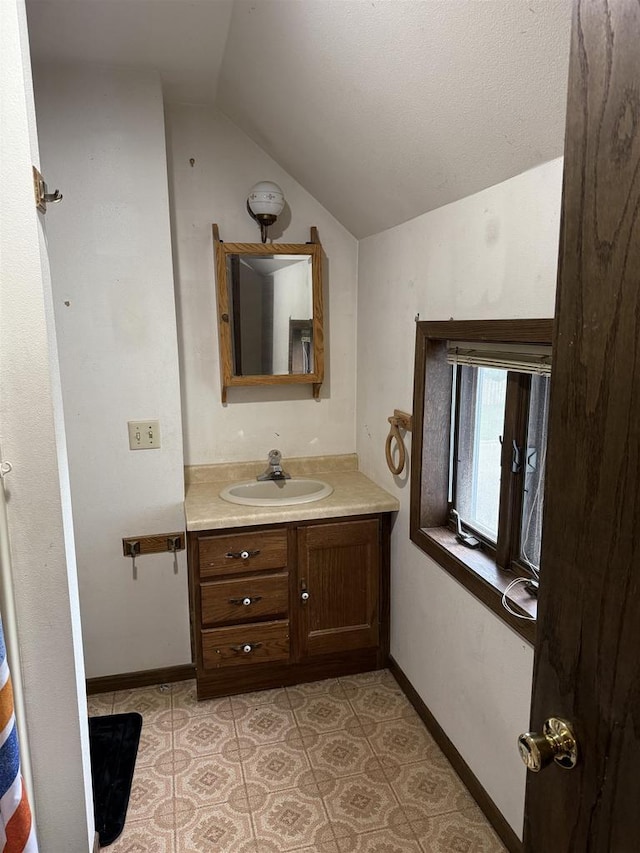 404 Prairie St, Mauston, WI 53948 - bathroom featuring lofted ceiling and vanity