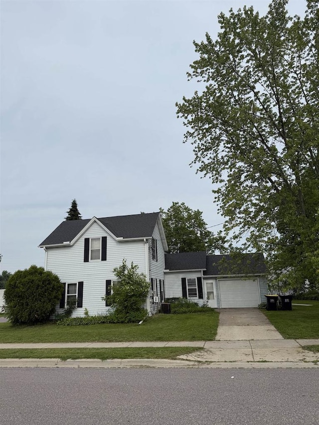 404 Prairie St, Mauston, WI 53948 - view of front of property with driveway, a front yard, and an attached garage