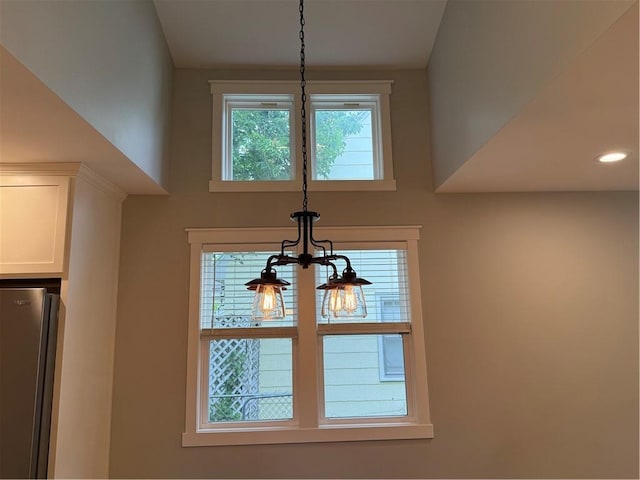 1028 Chauncey St, Eau Claire, WI 54701 - kitchen view of freestanding refrigerator, white cabinetry, pendant lighting, and recessed lighting