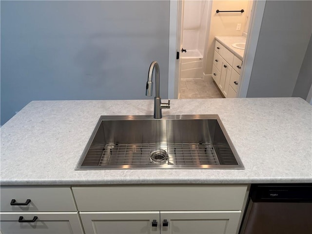 1028 Chauncey St, Eau Claire, WI 54701 - detailed view of stainless steel dishwasher, light countertops, and white cabinetry