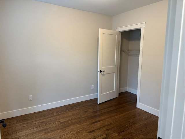 1028 Chauncey St, Eau Claire, WI 54701 - unfurnished bedroom featuring dark wood-type flooring and a closet