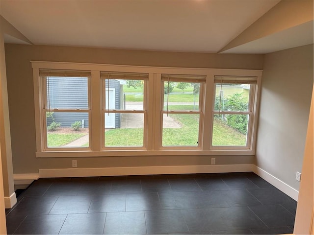1028 Chauncey St, Eau Claire, WI 54701 - unfurnished room featuring lofted ceiling and dark tile patterned flooring